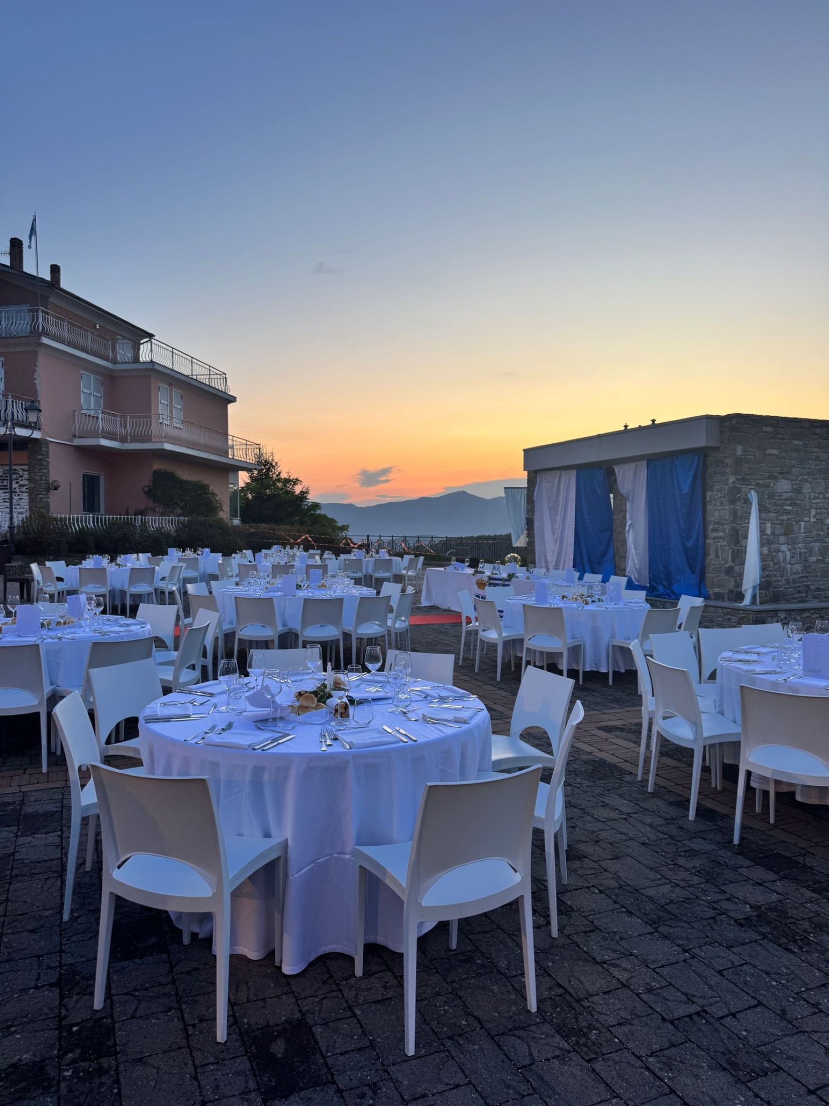 Riviera dinner terrace at dusk with mountain views